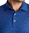 man wearing a peter millar Whiskey Sour Performance Jersey Polo